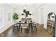 A beautifully staged dining room features modern furnishings, decor, and lighting, with hardwood floors at 18203 Sunbrook Way, Westfield, IN 46074