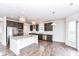 Open kitchen featuring granite countertops, a large island, stainless appliances, and hardwood floors at 18203 Sunbrook Way, Westfield, IN 46074