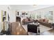 Open living room with hardwood floors, fireplace, and windows connecting to the dining and kitchen area at 18203 Sunbrook Way, Westfield, IN 46074