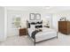 Well-lit main bedroom with hardwood floors, neutral decor, and bedside tables with reading lamps at 18203 Sunbrook Way, Westfield, IN 46074