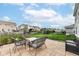 Outdoor patio seating area with a view of the grassy backyard at 18203 Sunbrook Way, Westfield, IN 46074