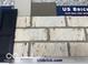 Close-up of brick sample, showcasing weathered white bricks and a dark shutter at 20342 Hudson Bay Ln, Westfield, IN 46074