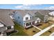 Aerial view of a blue two-story home in a manicured neighborhood, showcasing curb appeal at 2156 W 171St St, Westfield, IN 46074