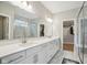 Bright bathroom boasts double sinks, white cabinets, large mirror, and elegant shower at 2156 W 171St St, Westfield, IN 46074