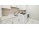 Clean laundry room features white cabinets, granite countertops, and modern appliances at 2156 W 171St St, Westfield, IN 46074