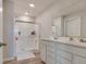 Bright bathroom featuring a double vanity and a large shower with glass doors at 2208 Gambel Ln, Danville, IN 46122