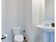 Powder room featuring a toilet, pedestal sink, and gray vinyl flooring at 2208 Gambel Ln, Danville, IN 46122