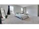 Sunlit bedroom with neutral carpet, light green bedding, and a full-length mirror at 2208 Gambel Ln, Danville, IN 46122