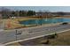 Scenic aerial of the neighborhood entrance, featuring a pond, fountain, and mature trees at 2208 Gambel Ln, Danville, IN 46122