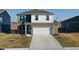 Two-story home showcasing a brick and white facade, a two-car garage, and a well-manicured lawn at 2208 Gambel Ln, Danville, IN 46122
