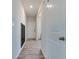 Hallway featuring light gray flooring, white walls, and a black shelving unit at 2208 Gambel Ln, Danville, IN 46122
