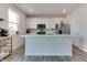 Bright kitchen featuring white cabinets, stainless steel appliances, and an island with a marble countertop at 2208 Gambel Ln, Danville, IN 46122