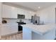 Bright, modern kitchen with white cabinets, stainless steel appliances, and a marble countertop island at 2208 Gambel Ln, Danville, IN 46122
