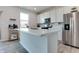 Bright kitchen featuring white cabinets, stainless steel appliances, and an island with a marble countertop at 2208 Gambel Ln, Danville, IN 46122