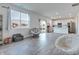Bright living room featuring modern finishes, wood-look flooring and natural light from large windows at 2208 Gambel Ln, Danville, IN 46122