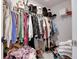 Walk-in closet with hanging clothes, shelving, and piled items at 2208 Gambel Ln, Danville, IN 46122