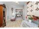 Neutral foyer boasts tile floors, a quilt wall hanging, and an entry to a formal dining room at 2315 Starlight Dr, Anderson, IN 46012