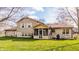 The backyard features siding and stone, a screened in porch, and a lush green lawn at 2605 Rollins Ct, Indianapolis, IN 46268
