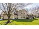 Lovely backyard featuring siding and stone with lush green lawn and shade from a mature tree at 2605 Rollins Ct, Indianapolis, IN 46268