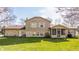 The backyard features siding and stone, a screened in porch, and a lush green lawn at 2605 Rollins Ct, Indianapolis, IN 46268