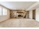 Spacious carpeted basement featuring a charming stone fireplace and neutral paint at 2605 Rollins Ct, Indianapolis, IN 46268