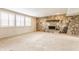 Bright basement area with a stone fireplace and large windows for plenty of natural light at 2605 Rollins Ct, Indianapolis, IN 46268
