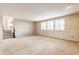 Open basement area with carpet, natural light, and stairs to the main floor at 2605 Rollins Ct, Indianapolis, IN 46268