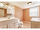 Bathroom with a vanity, toilet, and laundry machines, featuring white cabinets at 2605 Rollins Ct, Indianapolis, IN 46268