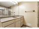 Bathroom vanity features a gray countertop, updated fixtures, and a shower with decorative tile at 2605 Rollins Ct, Indianapolis, IN 46268