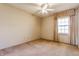 Bedroom with neutral walls and tan carpet with a window and light colored curtains at 2605 Rollins Ct, Indianapolis, IN 46268
