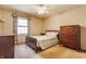 Bedroom with neutral walls, patterned bedding, and dark wood furniture at 2605 Rollins Ct, Indianapolis, IN 46268