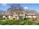 Two-story home with a well-maintained lawn and mature trees showcasing a welcoming curb appeal at 2605 Rollins Ct, Indianapolis, IN 46268