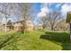 Charming home featuring a well-manicured lawn and a mix of brick and siding exterior under a partly cloudy sky at 2605 Rollins Ct, Indianapolis, IN 46268