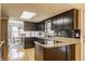 Bright kitchen showcases black cabinets, granite countertops, and stainless steel appliances and hardwood floors at 2605 Rollins Ct, Indianapolis, IN 46268