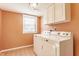 Laundry room with machines, white cabinets, a window and neutral paint at 2605 Rollins Ct, Indianapolis, IN 46268