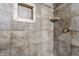 Close up view of the decorative tile and shelves of a newly renovated shower at 2605 Rollins Ct, Indianapolis, IN 46268