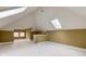 Finished attic with skylights, carpeted floor, neutral paint and views from the windows at 2620 Central Ave, Indianapolis, IN 46205