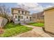Charming two-story home featuring a backyard with lawn, mature tree, and back porch at 2620 Central Ave, Indianapolis, IN 46205
