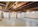Unfinished basement with exposed ceiling, concrete floor, and support beams at 2620 Central Ave, Indianapolis, IN 46205