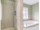 Bathroom featuring a tiled standup shower with glass door, and jacuzzi tub at 2620 Central Ave, Indianapolis, IN 46205
