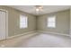 Bright bedroom with neutral carpet, ceiling fan, and a view of the windows at 2620 Central Ave, Indianapolis, IN 46205