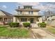 Charming two-story home with a brick facade, front porch and well-maintained landscaping at 2620 Central Ave, Indianapolis, IN 46205