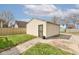 A single-car garage with a side entry door and pathway from the house at 2620 Central Ave, Indianapolis, IN 46205