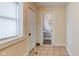Bright hallway with tile floors, door to backyard, and an open doorway to the bathroom at 2620 Central Ave, Indianapolis, IN 46205
