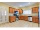 Well-equipped kitchen with stainless steel appliances, wood cabinets, and tile flooring at 2620 Central Ave, Indianapolis, IN 46205