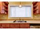 Cozy kitchen featuring a stainless steel sink, wooden cabinets and view of the window at 2620 Central Ave, Indianapolis, IN 46205