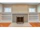 Cozy living room with a brick fireplace, built-in bookshelves, and bright windows at 2620 Central Ave, Indianapolis, IN 46205