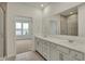 Bright bathroom featuring double sink vanity with a large mirror and a tiled shower in the background at 268 Onset Way, Westfield, IN 46074