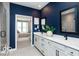 Sleek bathroom featuring double sinks, white cabinets, black fixtures, and tiled walk-in shower at 268 Onset Way, Westfield, IN 46074