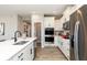 Well-lit kitchen with modern appliances, white cabinetry, tile backsplash, and wood floors at 268 Onset Way, Westfield, IN 46074